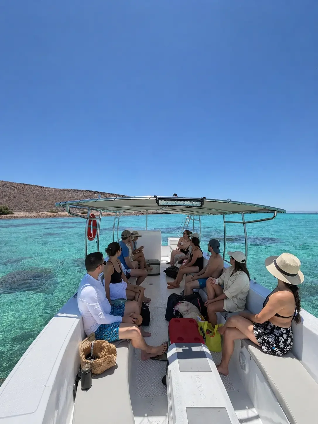 Travelers aboard a boat on the clear waters of Espíritu Santo Island
